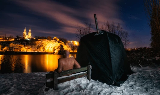Tent sauna at night with a castle view