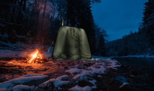 Tent sauna and campfire at dusk